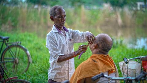 Traditional Outdoor Barber Giving a Shave in Rural India
